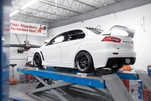 White EVO X on alignment rack getting corner balanced